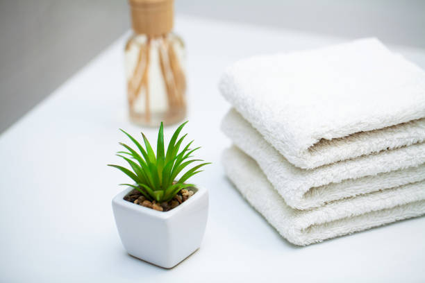 istock White towels on white table with copy space on bath room background 1179460637
