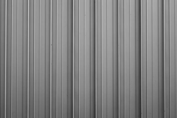 istock Front view of gray ribbed metal surface on fence or wall for backdrop 1179462554