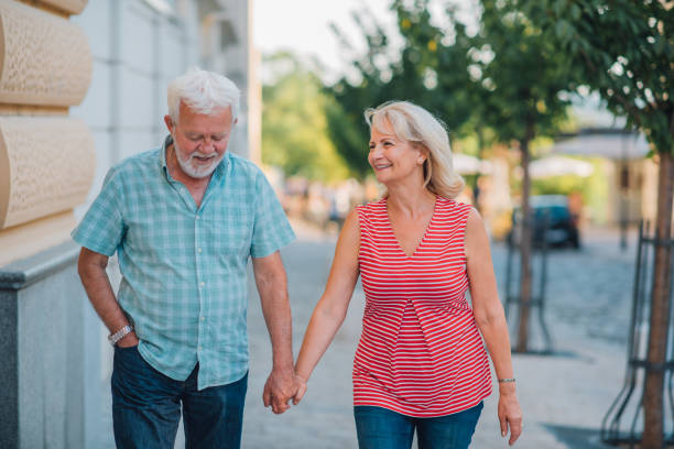 istock Elderly couple walking down the street 1179463279
