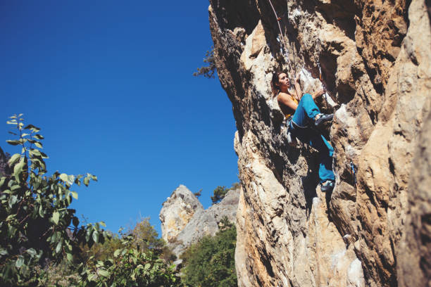 istock Woman climbs a rock. 1179463537