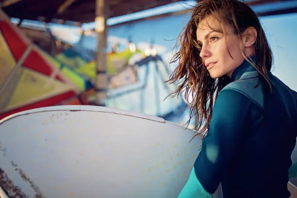 Portrait of young woman after windsurfing in the ocean