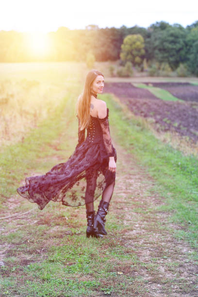 istock Young goth woman walking in nature 1179465976