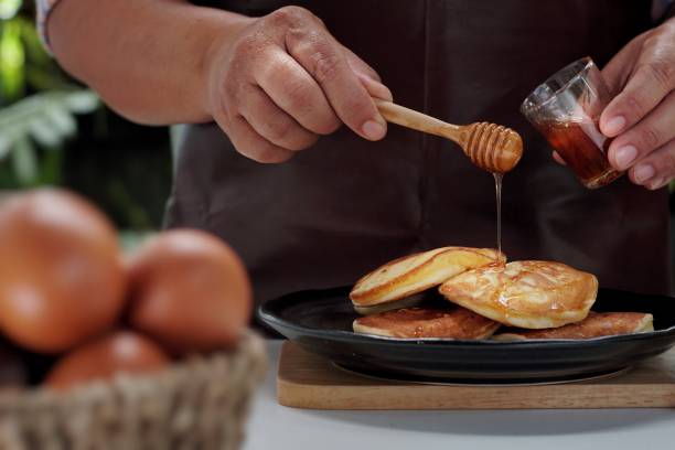 istock Pancakes served honey on table, healthy breakfast for everyday. 1179475319