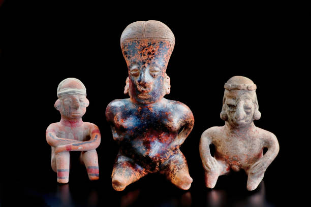 Intricately designed ancient ceramic figurine displayed in a museum, Bottle belonging to the Moche culture, represents Ai Apaec (Moche main god).Peruvian pre-Columbian ceramics, also known as Huacos in Peru.