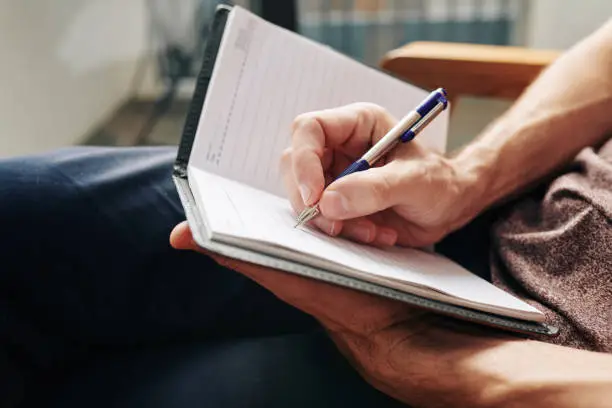 Photo of Man writing down thoughts