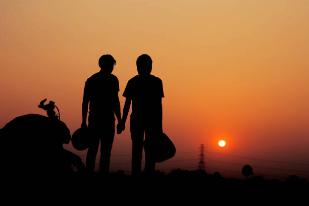 Couple of biker with nature and the sky at sunset.