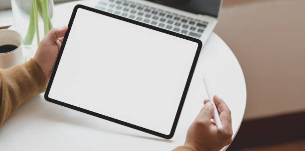 istock Close-up view of young man holding blank screen horizontal tablet 1179480747