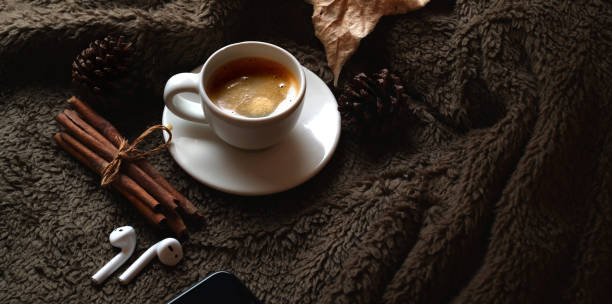 Coffee cup with office supplies on brown fur desk background with copy space