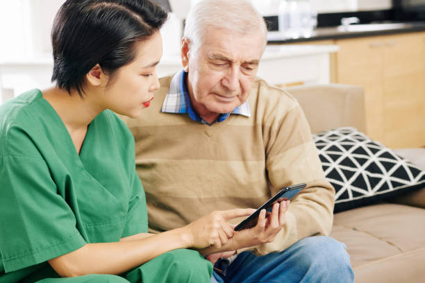 istock Caregiver showing mobile app to patient 1179482256
