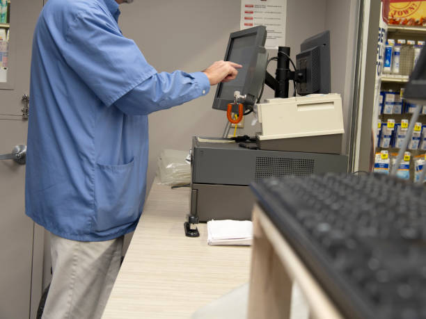 Pharmacist working a cash register stock photo