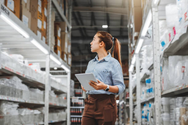 istock Asian woman worker working with digital tablet checking boxes Logistic import and export supplies packages in Warehouse , Logistics concept 1179485263