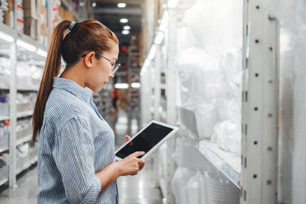 istock Asian woman worker working with digital tablet checking boxes Logistic import and export supplies packages in Warehouse , Logistics concept 1179485271