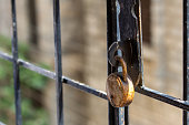 Rusted old lock on a iron grill for safety