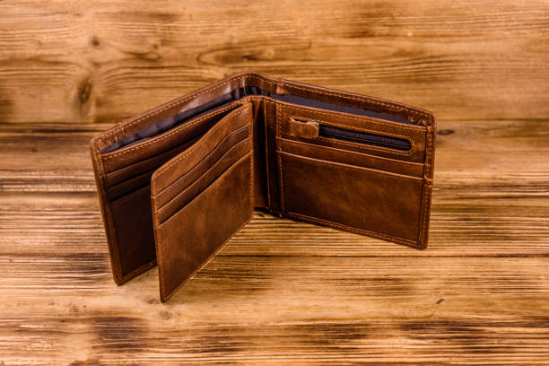 istock Opened brown leather wallet on wooden table 1179488065