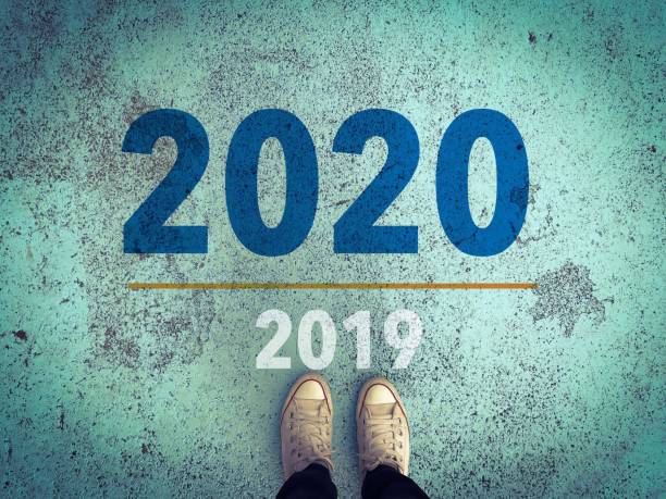 istock 2019 move to 2020 with white vintage sneakers shoe light blue background 1179488114