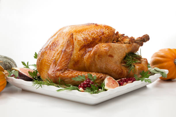 istock Traditional Roasted Turkey on White With Pumpkin 1179489982