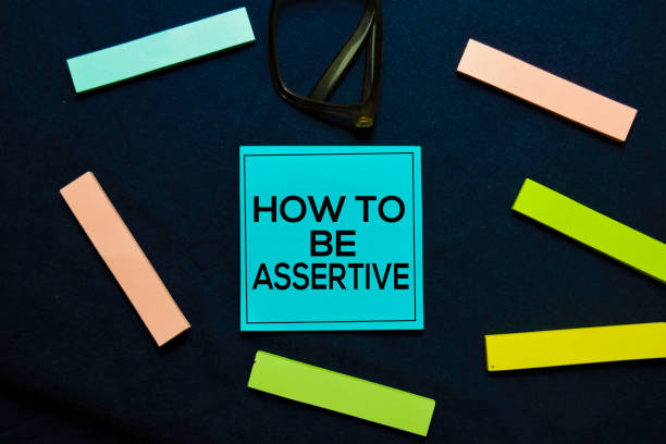 istock How To Be Assertive text on sticky notes isolated on office desk. 1179491304