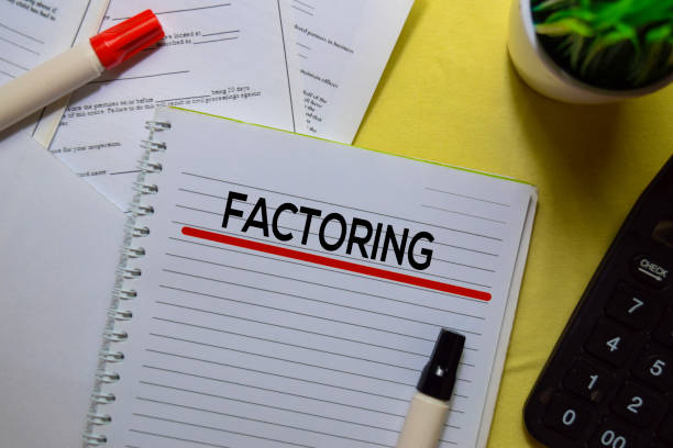 istock Factoring text on a book isolated on office desk. 1179491360