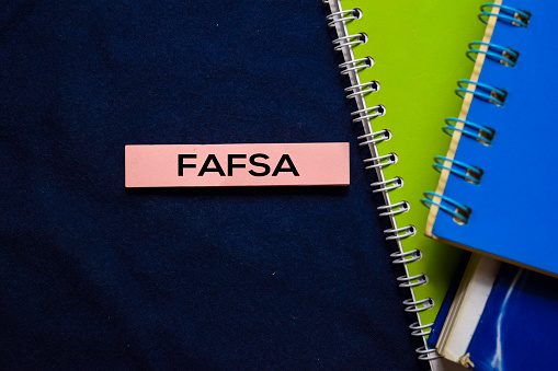 Free Application For Federal Student Aid (FAFSA) on sticky Notes isolated on office desk