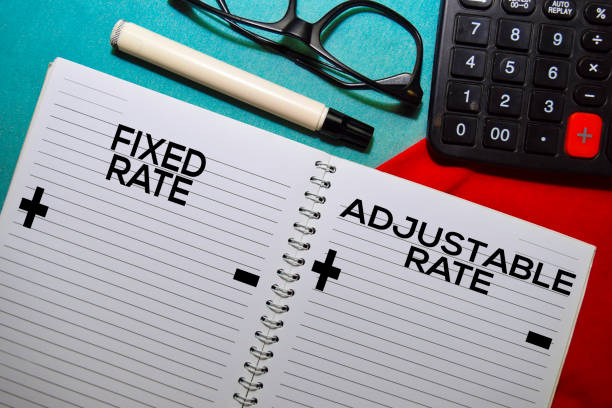 Fixed Rate and Adjustable Rate text on a book isolated on office desk. Fixed Rate and Adjustable Rate text on a book isolated on office desk. adjustable stock pictures, royalty-free photos & images