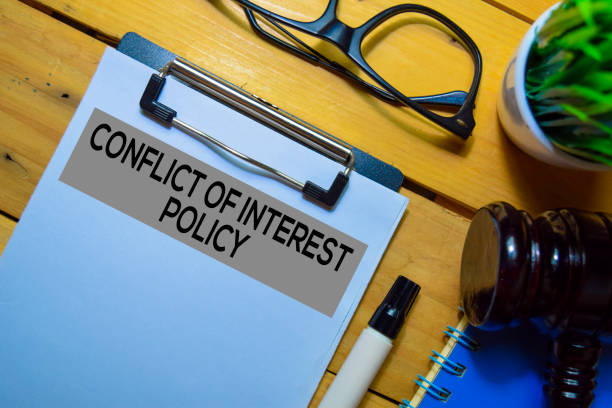 istock Conflict of Interest Policy text on Document form and Gavel isolated on office desk. 1179492578