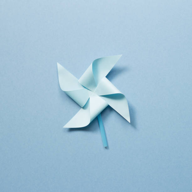 Blue paper pinwheel on blue background