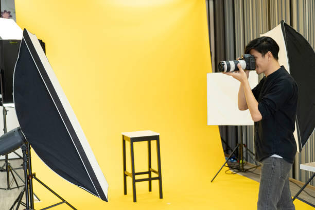 istock Young  Professional photographer with camera in on photo studio background. 1179493992