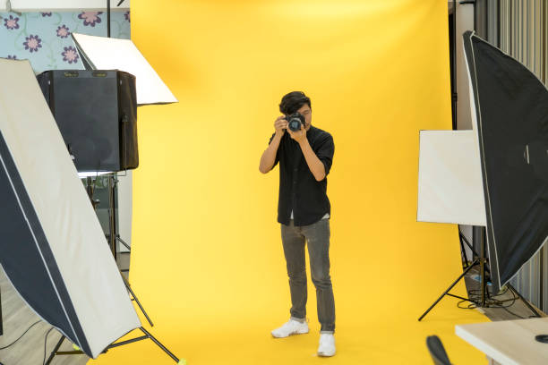 istock Young  Professional photographer with camera in on photo studio background. 1179493995