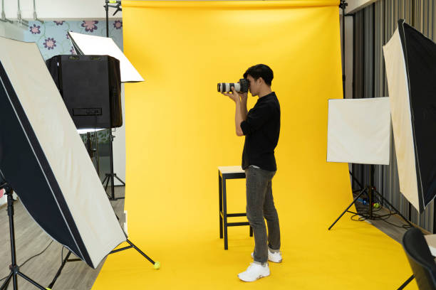 istock Young  Professional photographer with camera in on photo studio background. 1179493997