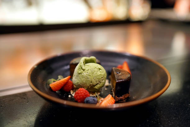 istock Matcha green tea ice cream with chocolate cake served with fresh strawberry, raspberry and blueberry. 1179496449