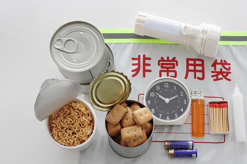 Emergency food at the time of disaster, dry bread, cup noodles, ramen, clock, battery, lighter, match, light bulb, candle, canned