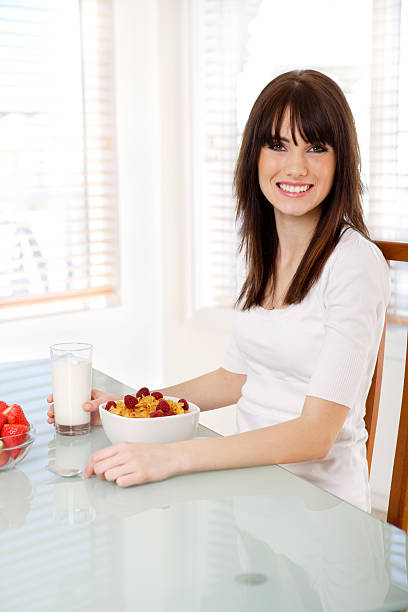istock Smiling teenager eating breakfast 117950037