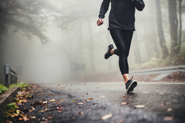 istock Unrecognizable athlete running on misty autumn day in the forest. 1179508323