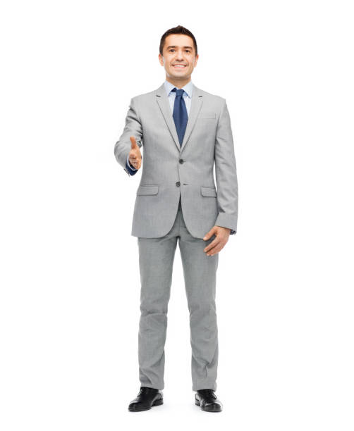 istock happy smiling businessman in suit shaking hand 1179508419