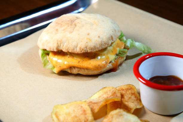 istock Burger with meat and vegetables. Double cheese burger.. Hot burger in a burning sauce. 1179511435