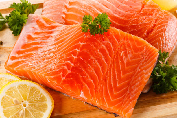 istock Fresh raw salmon steak on cutting board on white background 1179511723