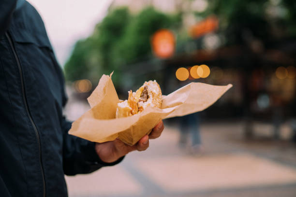 istock Man having food truck burger 1179511744