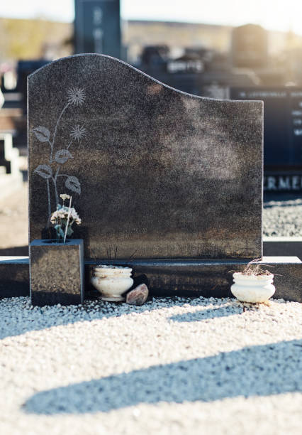 A dove sculpture leaning on a marmor gravestone