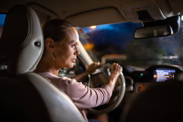 istock Young female driver driving her car at night 1179512955