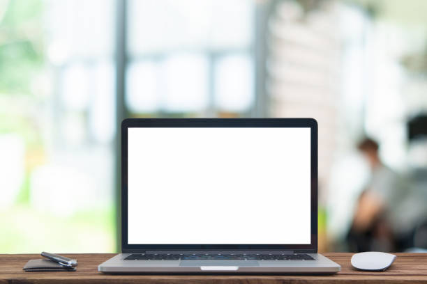 istock Desk Laptop with blank screen on table  blur background with bokeh background 1179513995