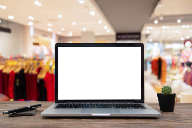 istock Desk Laptop with blank screen on table  blur background with bokeh background 1179514199