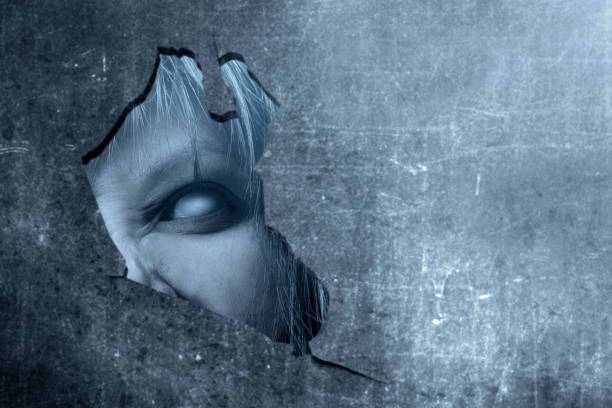 istock Scary zombies with angry face peek behind the broken walls 1179516460