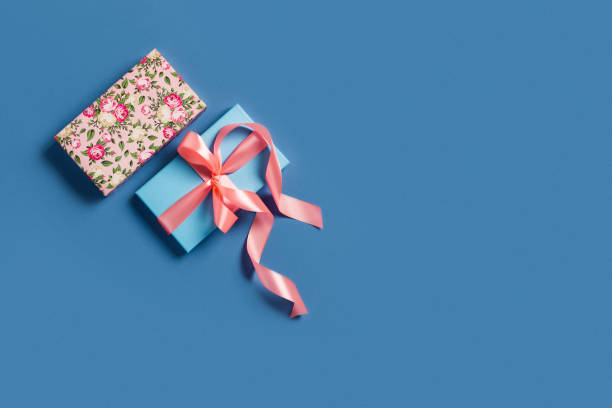 istock Festive blue background with gift box and bow. 1179516754