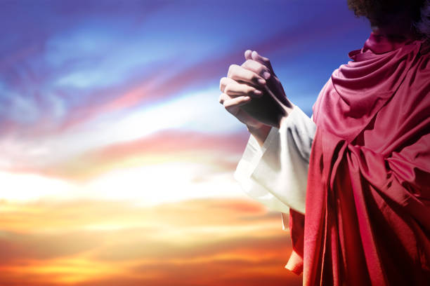 istock Jesus Christ raised hands and praying to god 1179517556
