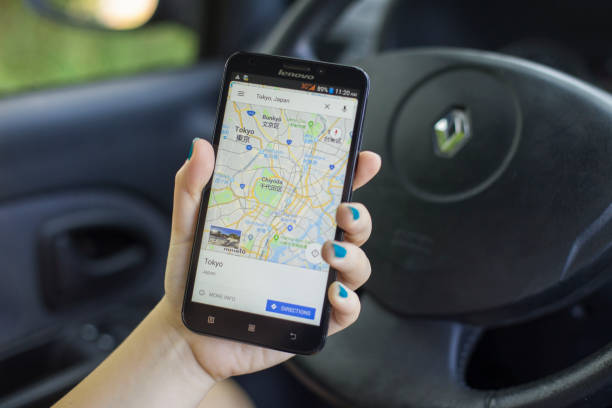Google Maps App Close-up of an unrecognizable woman using the Google Maps App on her Lenovo A916 Android smartphone in a car. Map of Tokyo, Japan shown on screen. destination tokyo japan on geographical map in close up image stock pictures, royalty-free photos & images