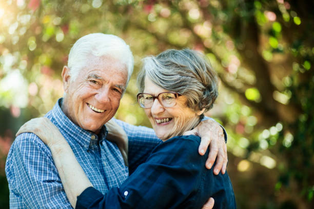 istock Happily embracing, senior couple smile at the camera 1179517780