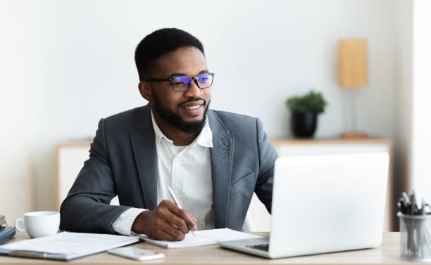 istock Handsome black entrepreneur working on laptop and taking notes 1179519142