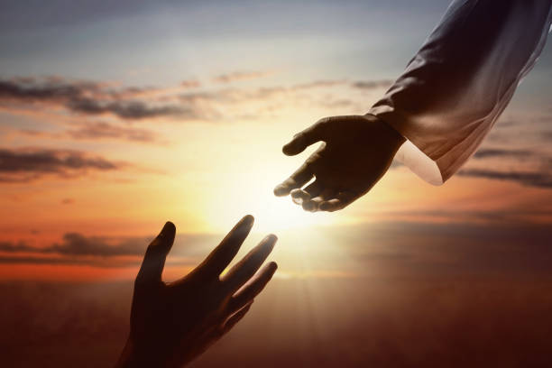 istock Jesus Christ giving a helping hand to human 1179519224