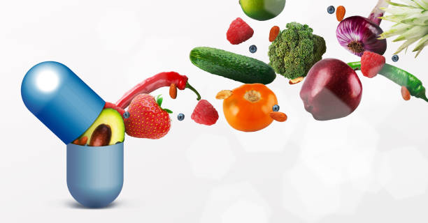 istock Vitamins pill with flying fruits on white background 1179519333