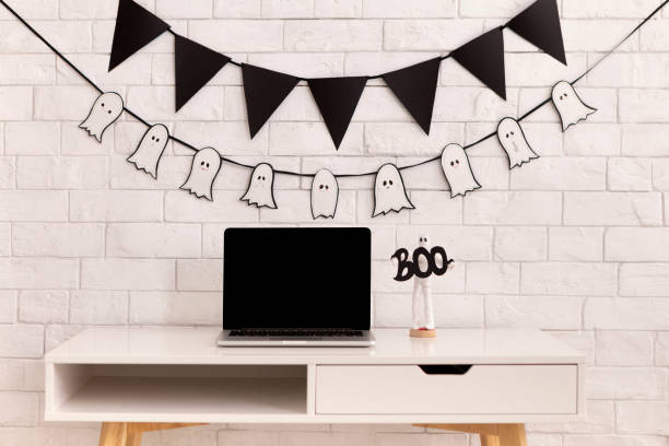 istock Halloween decorations in modern office with laptop 1179519682